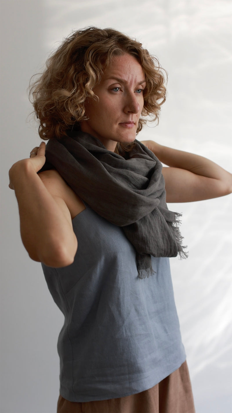 woman in dark gray Linen scarf and blue top