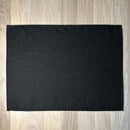Black-linen-placemat-on-wooden-table
