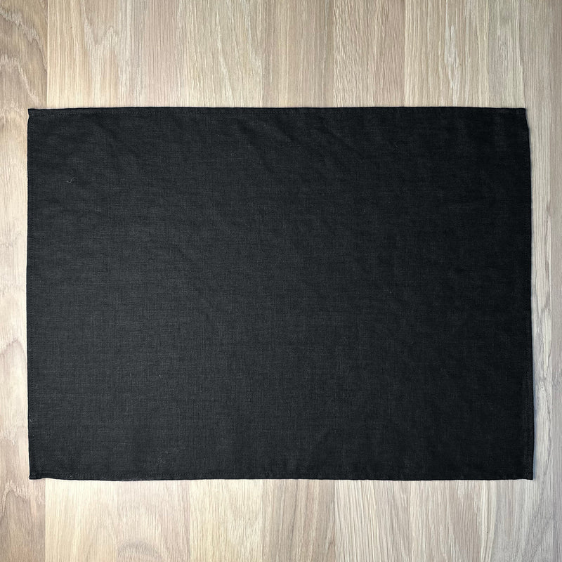 Black-linen-placemat-on-wooden-table