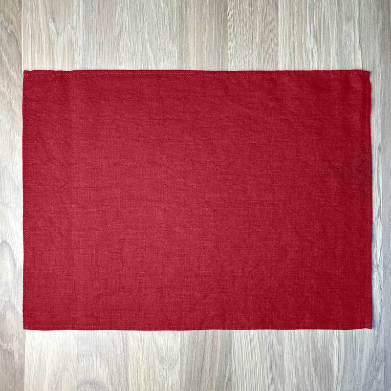 Carmine-red-linen-placemat-on-wooden-table