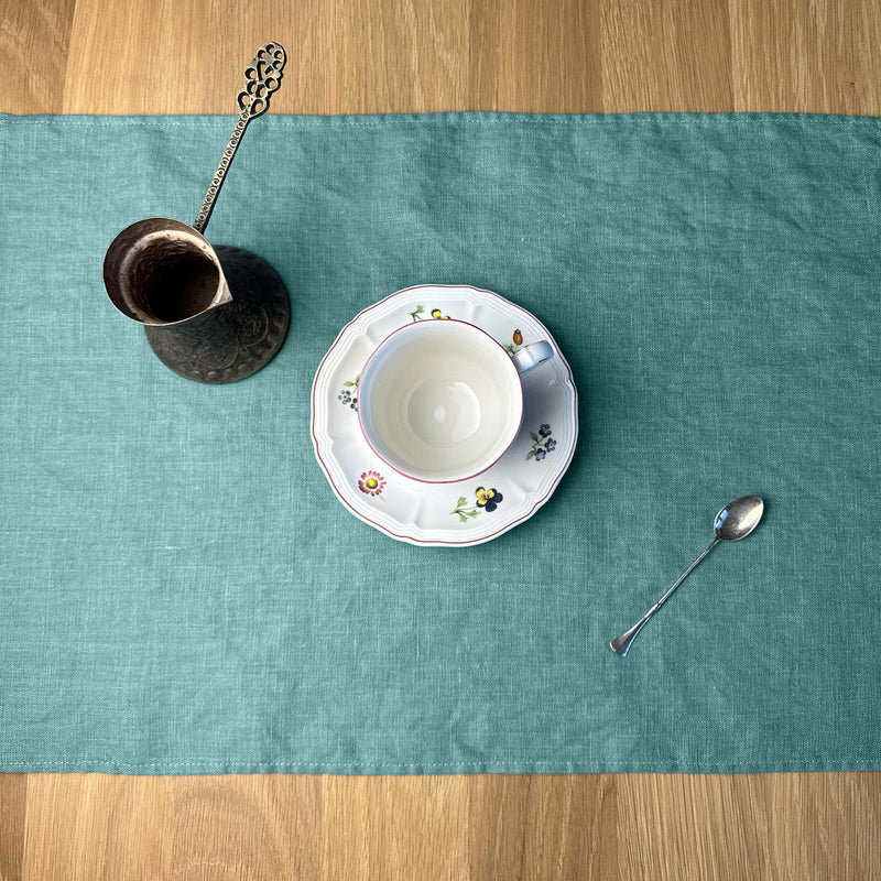 Cezve_-cup_-plate-and-little-spoon-on-turquoise-linen-placemat-on-wooden-table