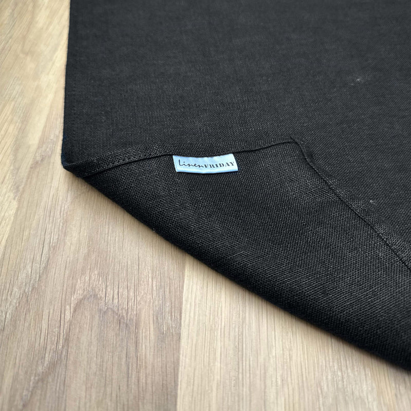 Corner-with-logo-LinenFriday-of-black-linen-placemat-on-wooden-table