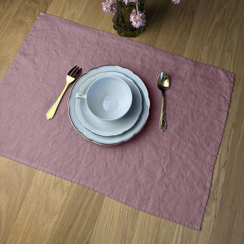 Flowers_-White-cup-fork-spoon-and-plates-on-desert-rose-Linen-placemat-on-wooden-table