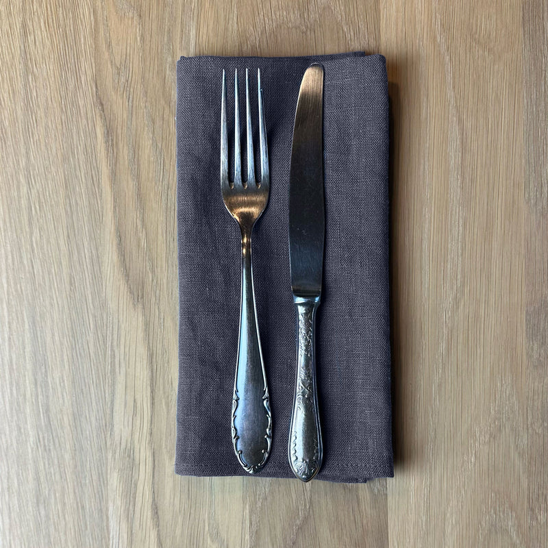 Fork-and-knife-on-anthracite-gray-linen-napkin