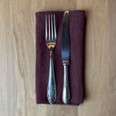 Fork-and-knife-on-aubergine-linen-napkin