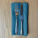 Fork-and-knife-on-petrol-blue-linen-napkin