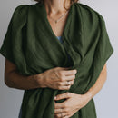 Person wearing a green scarf with a neutral background