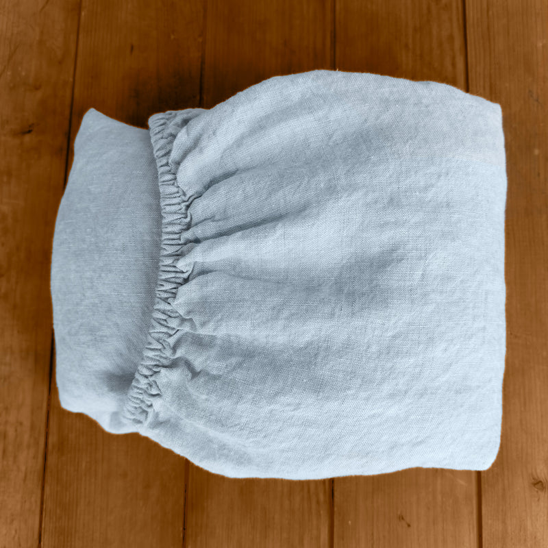 Linen fitted sheet ice blue on wooden box 2