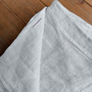 Linen flat sheet ice blue on wooden box with LinenFriday lable