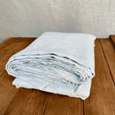 Linen flat sheet ice blue on wooden box 5. Flaches Leinenlaken in Eisblau auf Holzkiste 5