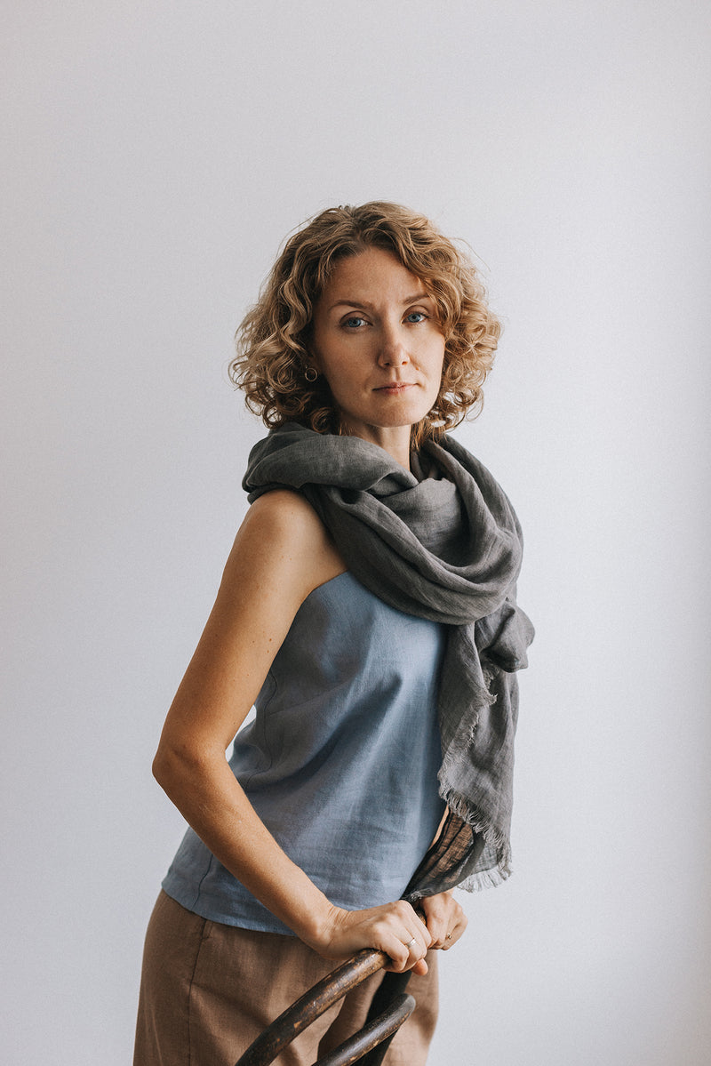 woman in gray Linen scarf and blue t-shirt