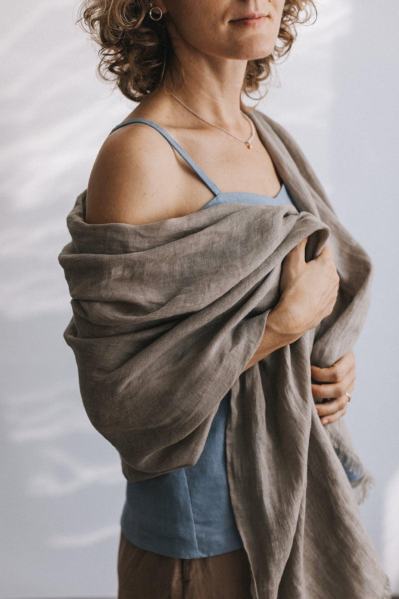woman in gray Linen scarf and blue t-shirt