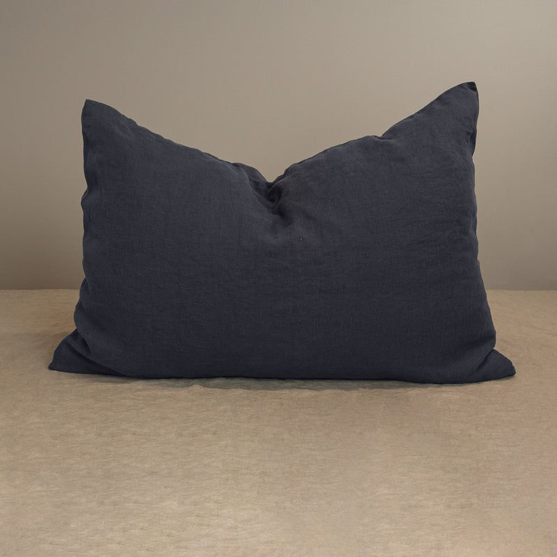 Linen pillow in anthracite gray pillowcase crumpled in the middle