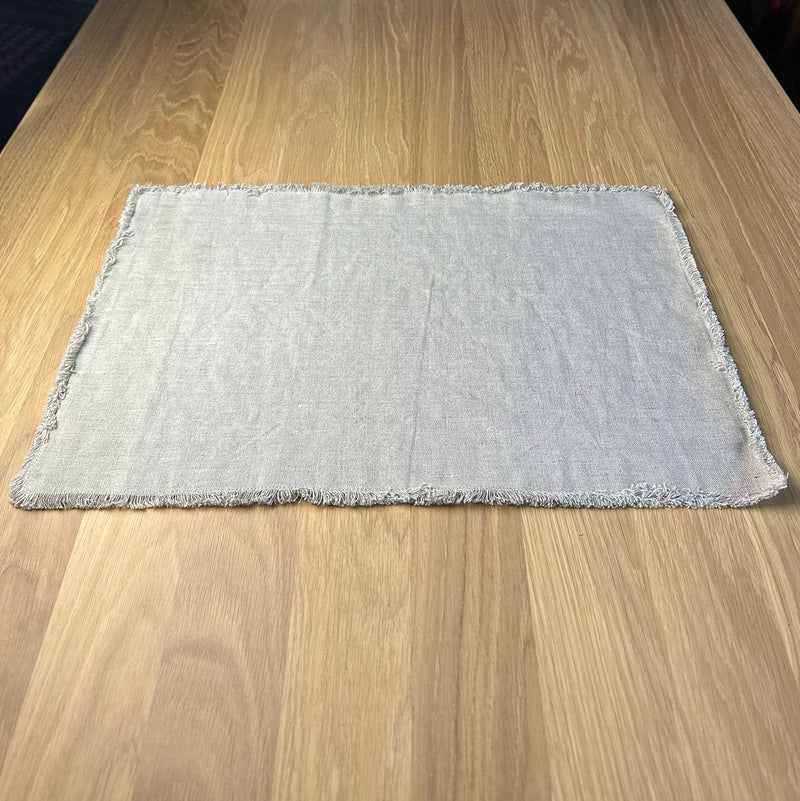 Natural gray Linen placemat with fringe on wooden table