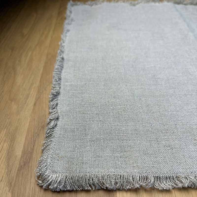 Natural gray Linen placemat with fringe on wooden table