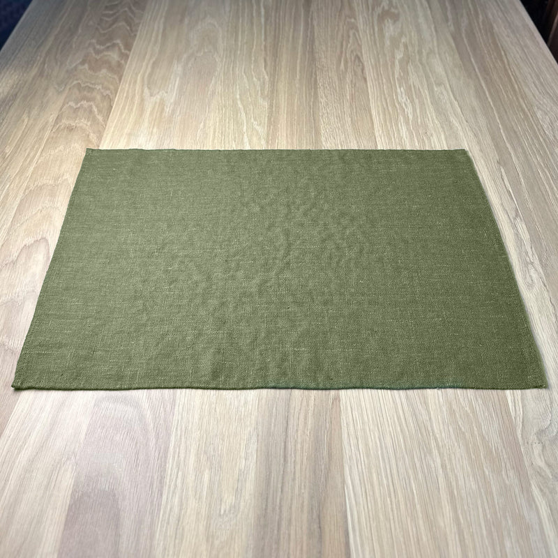 Olive-green-linen-placemat-on-wooden-table