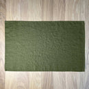 Olive-green-linen-placemat-on-wooden-table