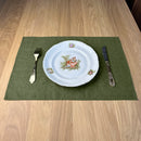 Plate-with-Man-and-woman_-fork-and-knife-on-olive-green-linen-placemat-on-wooden-table