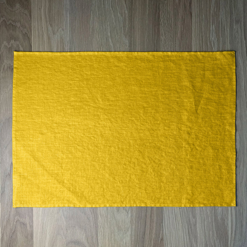 Sunny-yellow-linen-placemat-on-wooden-table