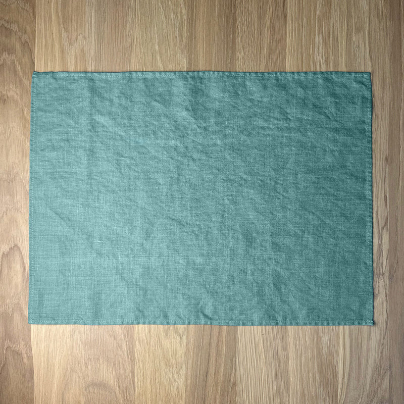 Turquoise-linen-placemat-on-wooden-table