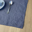 Plate-with-flowers_-knife-and-fork-on-anthracite-gray-linen-placemat-on-wooden-table