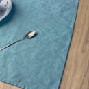 Cezve_-cup_-plate-and-little-spoon-on-turquoise-linen-placemat-on-wooden-table